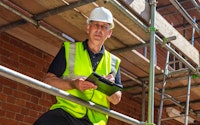 Construction builder on site scaffold 1917072851