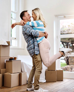 Portrait couple and hug for moving home box and man in living room happy in new house 2478771197