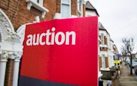An auction sign on typical street of british terraced houses 1306034665