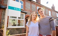 Couple young moving house conveyancing happy sold sign 1273188052