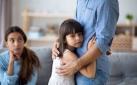Divorce seperation young girl hugs father sad 1401523019