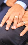 Family close up hands wedding rings same sex male gay couple 1222984513