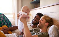 Family young same sex male couple with baby happy 1515641399