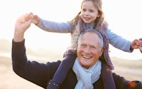 Happy grandad laughing with granddaughter piggyback 204799915