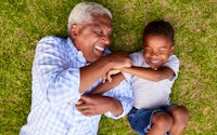 Happy grandad laughing with grandson 557001676