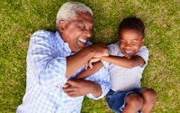 Happy grandad laughing with grandson 557001676